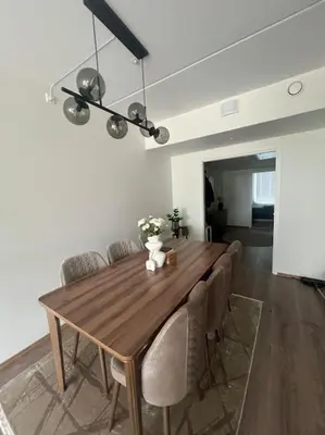 a dining room with a wooden table and chairs at SKI VM - Trondheim 2025 in Heimdal