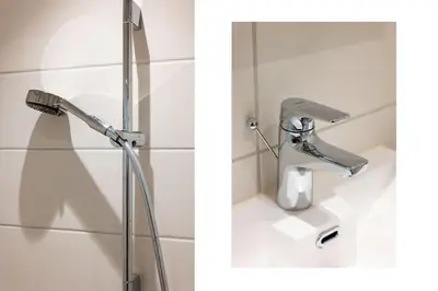 a shower head in a bathroom next to a sink at Cozy studio in Bergen center in Bergen