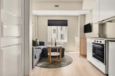 a kitchen and living room with a couch and a table at Cozy studio in Bergen center in Bergen