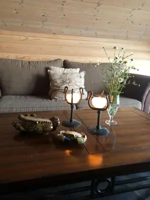 a coffee table with two candles on top of it at Moderne Rorbu helt i sjøkanten in Hauge