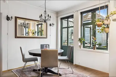 a dining room with a table and chairs and a window at Stylish & Modern Apartment, in Centre, Free Parking spot ! in Trondheim