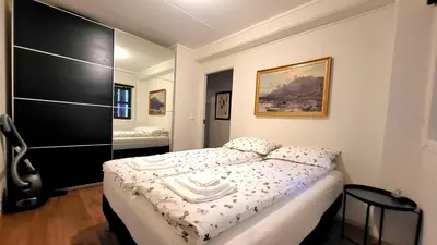 a small bedroom with a bed with a black cabinet at Stylish & Modern Apartment, in Centre, Free Parking spot ! in Trondheim