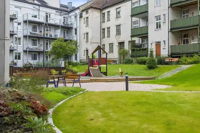 a park with a playground in front of buildings at Stylish & Modern Apartment, in Centre, Free Parking spot ! in Trondheim
