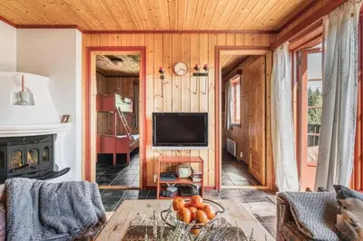 a living room with a television and a table at Leilighet sentralt i Trysil in Hovi