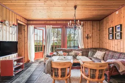 a living room with a couch and a table at Leilighet sentralt i Trysil in Hovi
