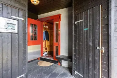 an entrance to a building with a red door at Leilighet sentralt i Trysil in Hovi