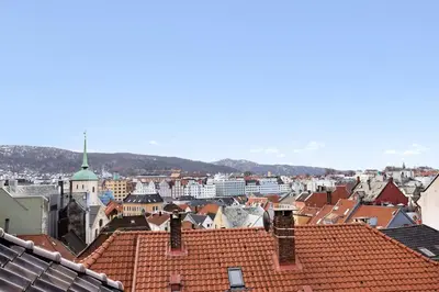 a view of a city with roofs and buildings at Historisk hus i hjertet av byen in Bergen