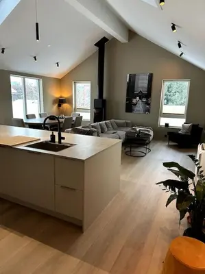 a living room with a kitchen and a living room with a couch at Enebolig Trondheim, familievennlig, nytt 2023 in Trondheim