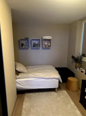 a bedroom with a bed with three pictures on the wall at Enebolig Trondheim, familievennlig, nytt 2023 in Trondheim
