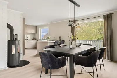 a kitchen and dining room with a table and chairs at Trolltunga Fjord View in Tokheim