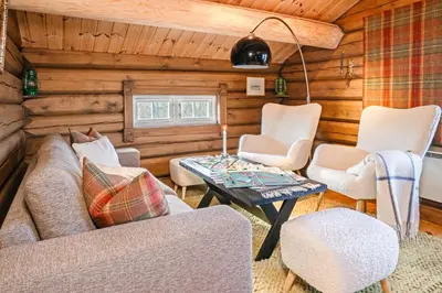 a living room with a couch and two chairs and a table at Tovebu Superior 9-sengshytte in Geilo