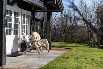 a stuffed animal sitting in a chair on a porch at Tovebu Superior 9-sengshytte in Geilo