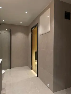 a bathroom with a toilet and a wall with a window at Chalet Chablis in Hemsedal