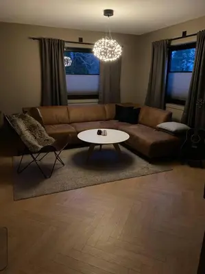 a living room with a couch and a table at Totalrenovert enebolig i rolige omgivelser in Trondheim