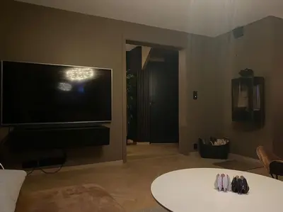a living room with a large flat screen tv at Totalrenovert enebolig i rolige omgivelser in Trondheim