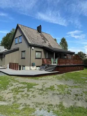 a house with a fence in front of it at Totalrenovert enebolig i rolige omgivelser in Trondheim