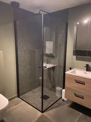 a bathroom with a shower with a toilet and a sink at Totalrenovert enebolig i rolige omgivelser in Trondheim