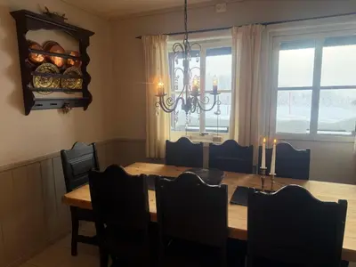 a dining room with a table and chairs and a chandelier at Cozy 3 Bedroom, Terrace, Pets Welcome in Beitostøl