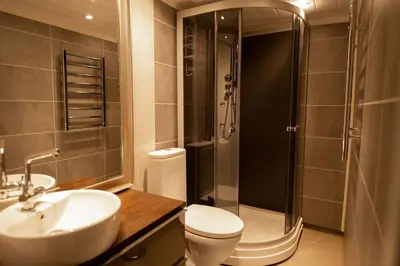 a bathroom with a sink and a toilet and a shower at Cozy apartment close to the ski resort in Oppdal