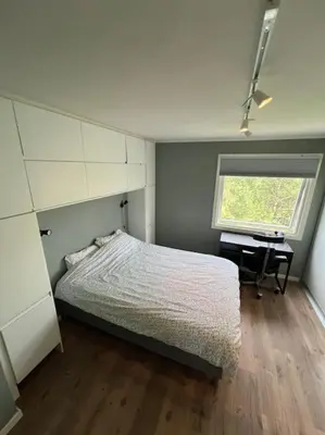 a bedroom with a bed and a desk and a window at Bolig til leie under ski-VM 2025 in Trondheim