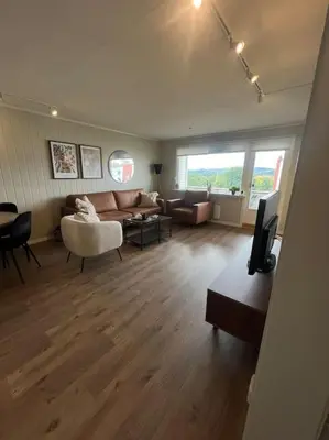 a living room with a couch and a table at Bolig til leie under ski-VM 2025 in Trondheim