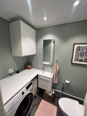 a laundry room with a washing machine and a sink at Bolig til leie under ski-VM 2025 in Trondheim