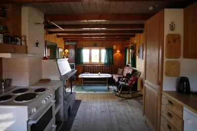 a kitchen with a stove and a table in it at Old Cabin Vibe, Perfect For Families Or Couples in Beitostøl