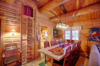 a dining room with a table and chairs in a cabin at Perfectly Located Timber Cabin For 6-8 Guests in Beitostøl