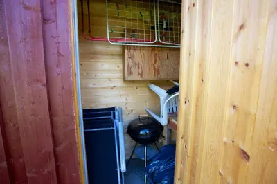 an inside view of a tiny house with a stove at Charming Cabin With Old Timber, Fireplace & Views in Beitostøl