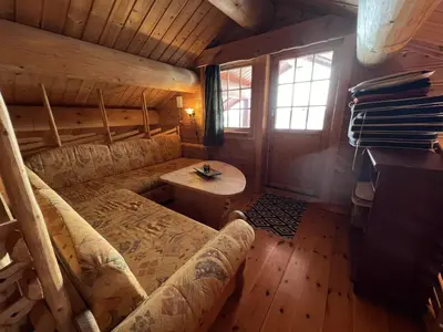 a living room with a couch and a table at Familiehytte Med Peis Og Badstu I Sentrum in Beitostøl
