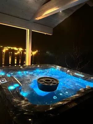 a hot tub with a tire in it at night at Tenden Panorama in Stryn