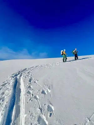 two people standing on top of a snow covered slope at Tenden Panorama in Stryn