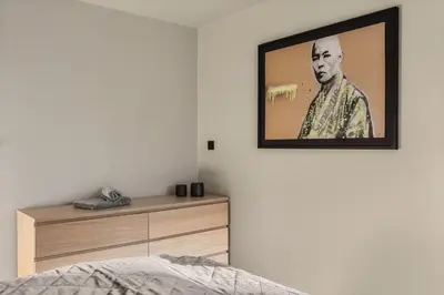 a bedroom with a picture of a man on the wall at Odda Trolltunga Atmosphere in Odda