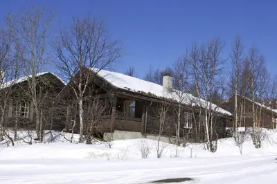 a house with snow on top of it at Koselig Sentral Eldre Hytte Med Peis in Beitostøl