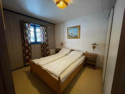 a small bedroom with a bed and a window at Your Perfect Base In Beitostølen Sleeps 8! in Beitostøl