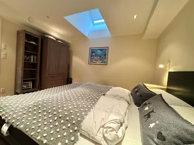 a bedroom with a bed and a skylight at Beautiful penthouse centrally located in Geilo, stunning views in Geilo