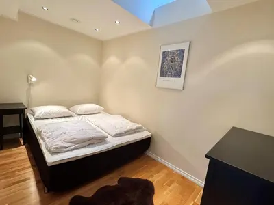 a small bedroom with a bed and a desk at Beautiful penthouse centrally located in Geilo, stunning views in Geilo