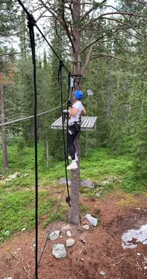 a person is climbing a tree on a zip line at Mountain Getaway With Sauna And Views in Beitostøl
