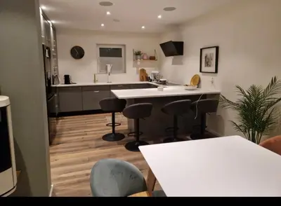 a kitchen with a counter and bar stools in it at Ski-VM i Trondheim 2025, house with 5 big bedrooms in Trondheim