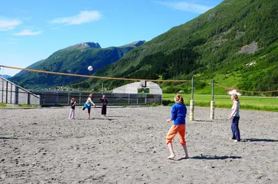 a group of children playing a game of volleyball at Bøyum Camping in Fjarland