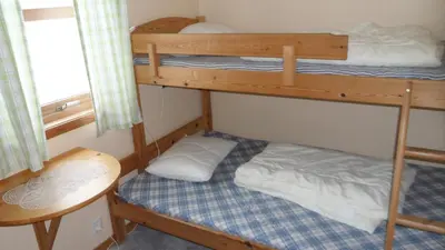 two bunk beds in a small room with a table at Bøyum Camping in Fjarland