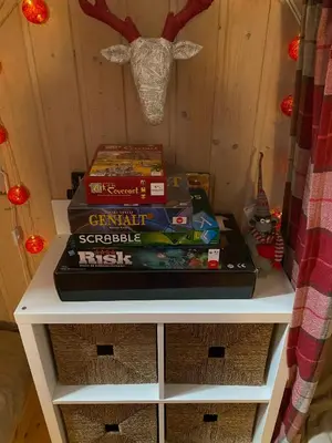 a stack of books on a shelf in a room at Perfect Retreat For Small Families in Beitostøl
