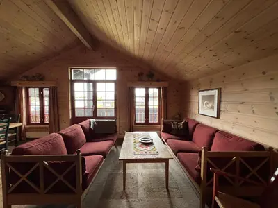 a living room with a couch and a table at Modern Retreat By Beitostølen Ski Stadium in Beitostøl
