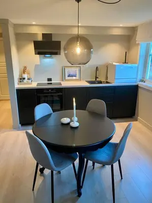 a kitchen with a table and chairs with a candle on it at Leilighet i enebolig in Fagernes