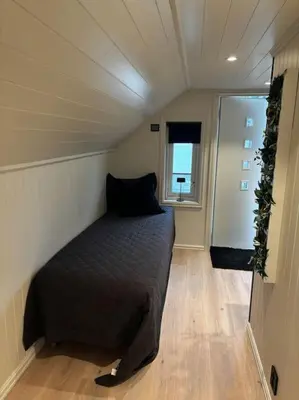 a bedroom with a bed in a room with a window at NY og moderne studioleilighet med elbil lading in Gjøvik