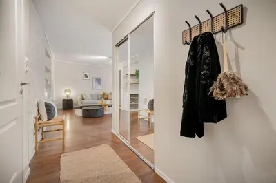a hallway with a mirror and a living room at Leilighet - midt i sentrum! in Bergen
