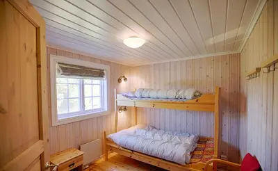 a room with two bunk beds and a window at Large Cabin Retreat Perfect For Family Gatherings in Beitostøl