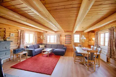a living room with a couch and a table at Large Cabin Retreat Perfect For Family Gatherings in Beitostøl