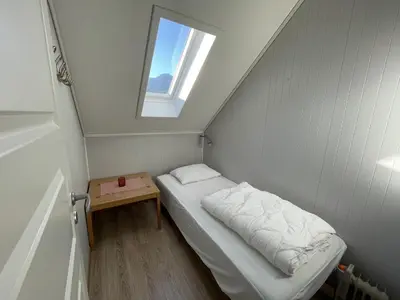 a small room with a bed and a small table at Sauda Fjord Camping in Saudasjøen