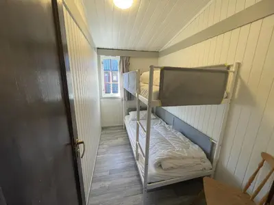 a small room with two bunk beds in it at Sauda Fjord Camping in Saudasjøen